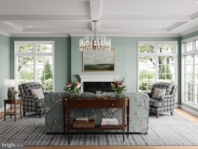 a living room with furniture a fireplace and large windows