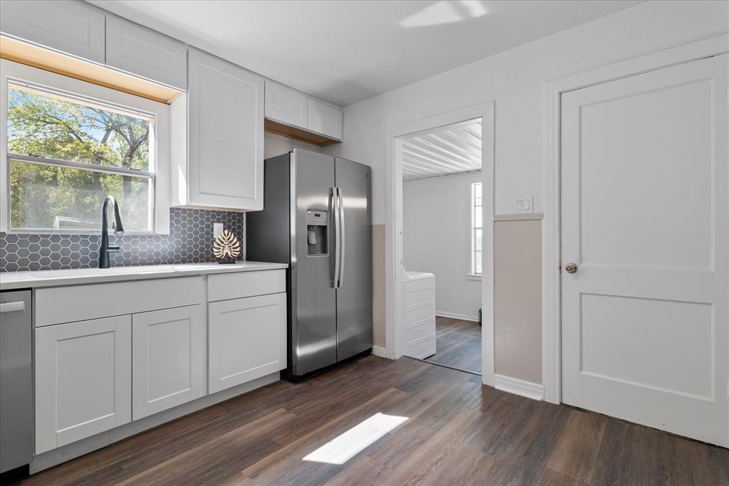 2411 Denison Street Denton, TX 76201 - Photo 7 of 15 a kitchen with stainless steel appliances granite countertop a refrigerator and a sink