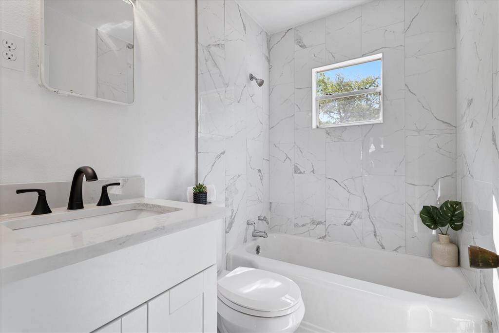 2411 Denison Street Denton, TX 76201 - Photo 10 of 15 a bathroom with a sink a toilet and shower