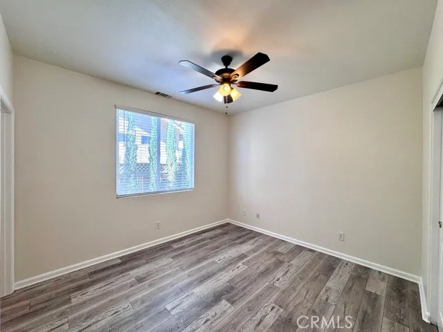a view of empty room with wooden floor
