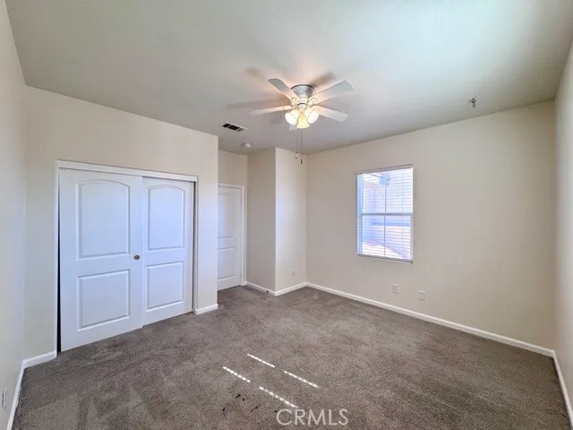 a spacious bathroom with double vanity and a mirror