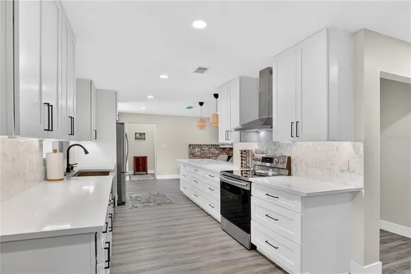 a kitchen with a sink stove and cabinets