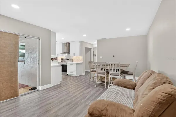 a living room with furniture and kitchen view