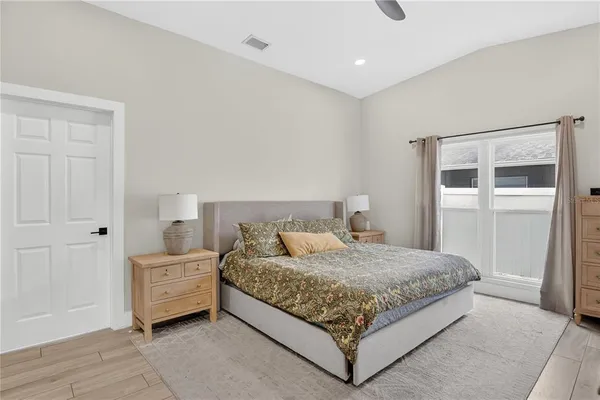 a bedroom with a large bed and a window