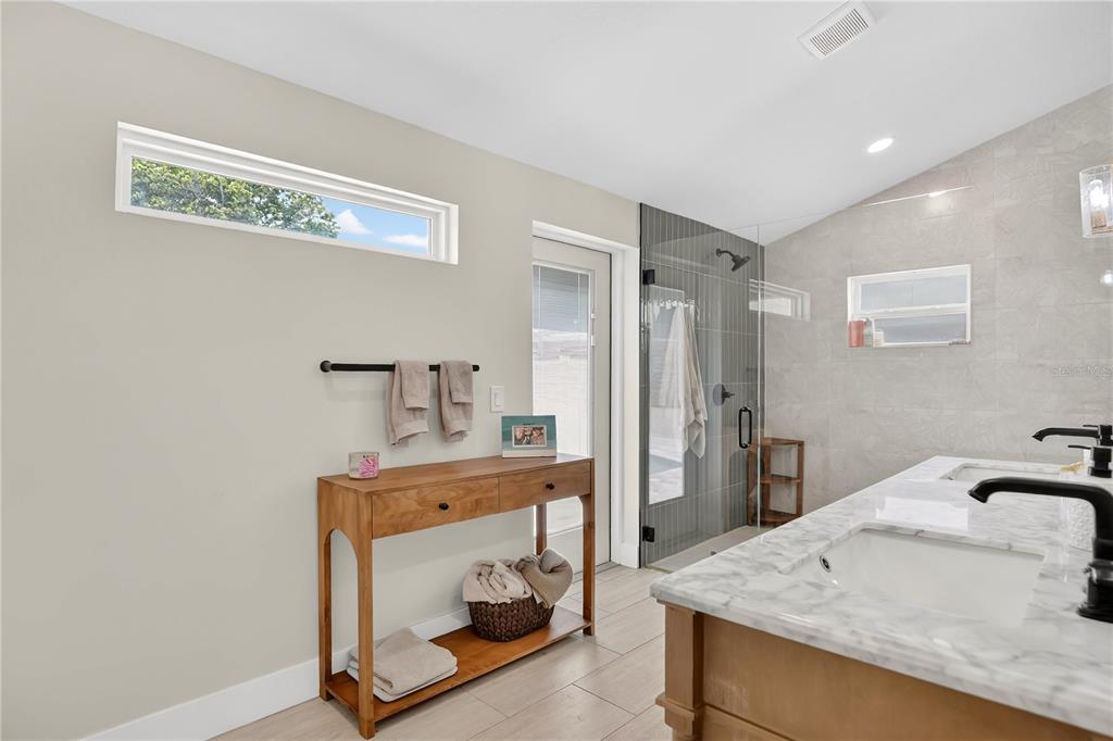 4222 Old Dominion Road Orlando, FL 32812 - Photo 17 of 49 a bathroom with a sink a vanity and shower