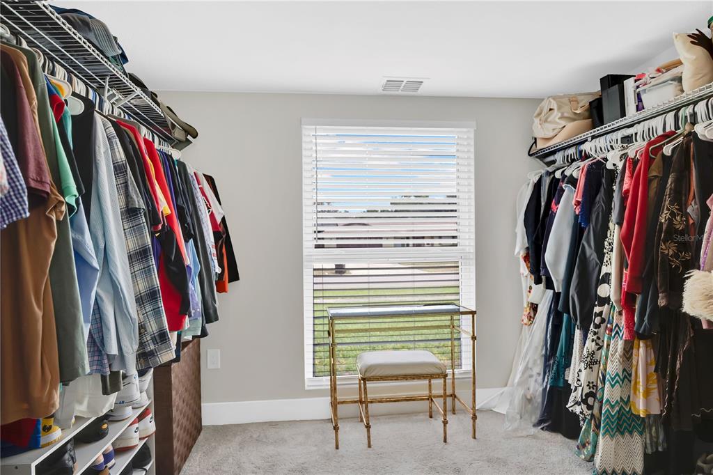 4222 Old Dominion Road Orlando, FL 32812 - Photo 18 of 49 a view of walk in closet with clothes and shoes