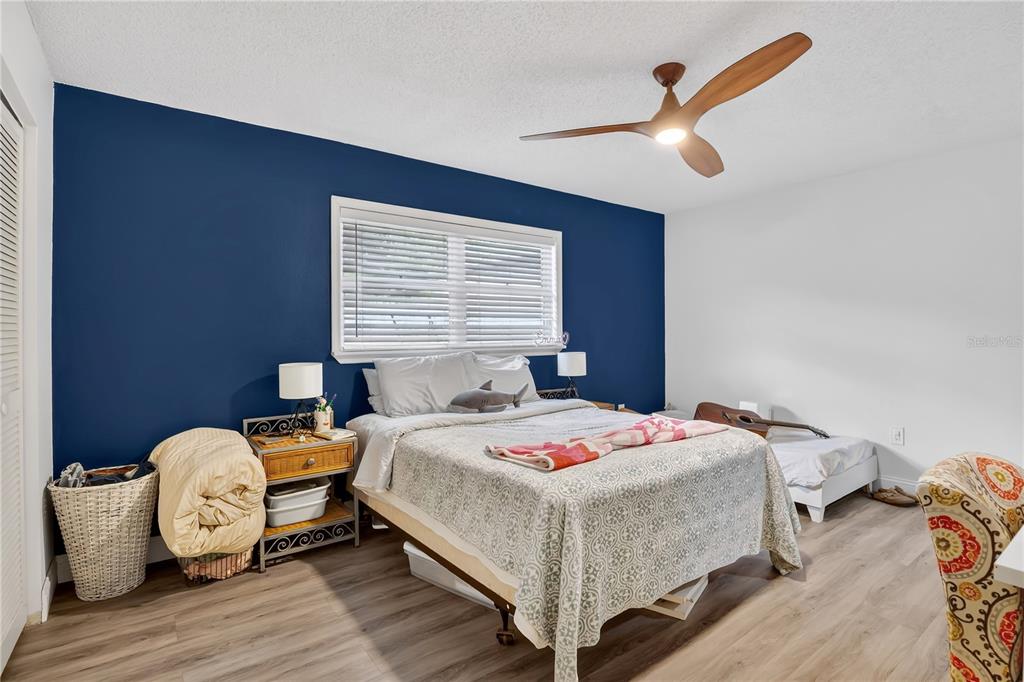 4222 Old Dominion Road Orlando, FL 32812 - Photo 20 of 49 a bedroom with a bed and wooden floor
