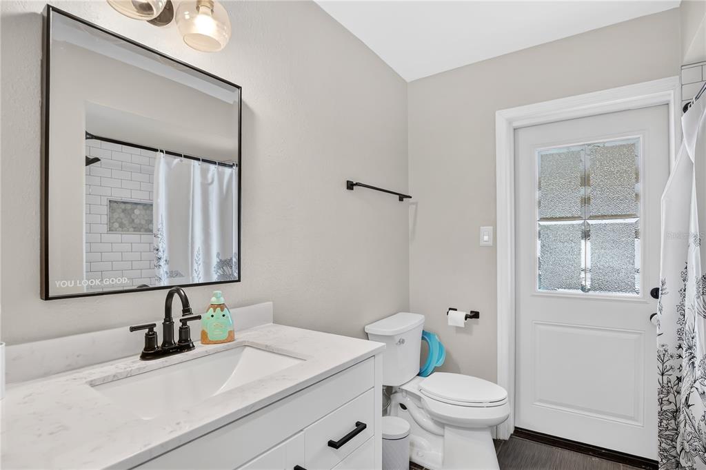 4222 Old Dominion Road Orlando, FL 32812 - Photo 23 of 49 a bathroom with a sink toilet and mirror