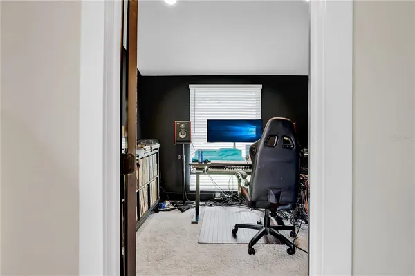 a view of a workspace with furniture and a window