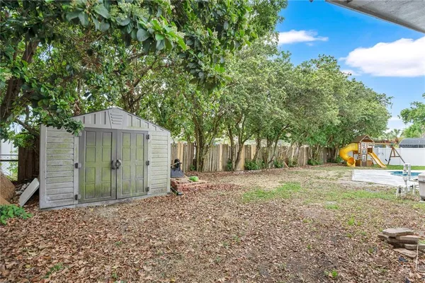 a backyard of a house with a table and chairs