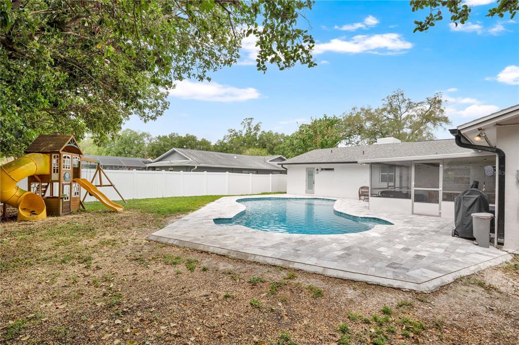 4222 Old Dominion Road Orlando, FL 32812 - Photo 29 of 49 a view of a house with a yard and a large tree