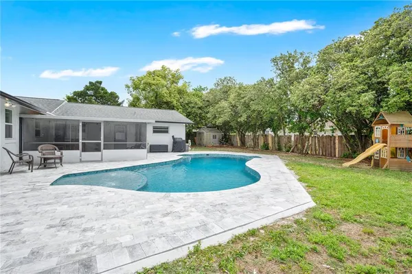 a view of a house with backyard and sitting area