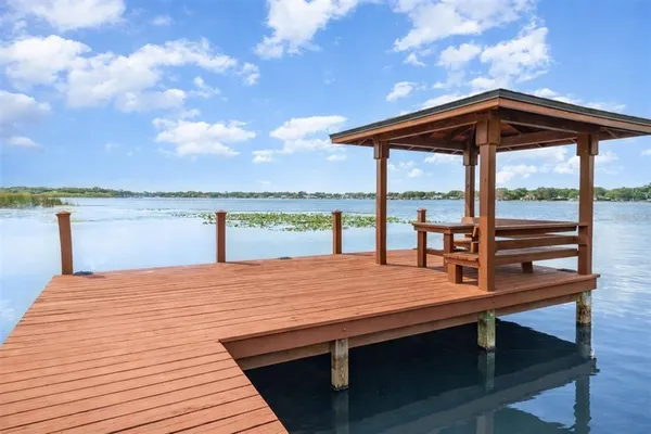 a wooden deck with sunset view