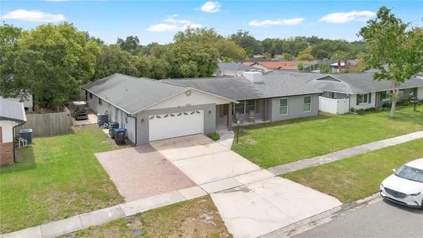 a aerial view of a house with a yard table and chairs