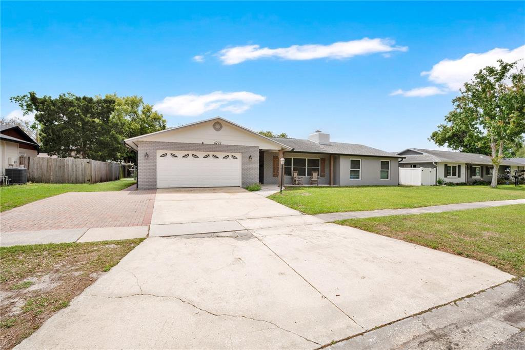 4222 Old Dominion Road Orlando, FL 32812 - Photo 40 of 49 a front view of a house with a yard and garage