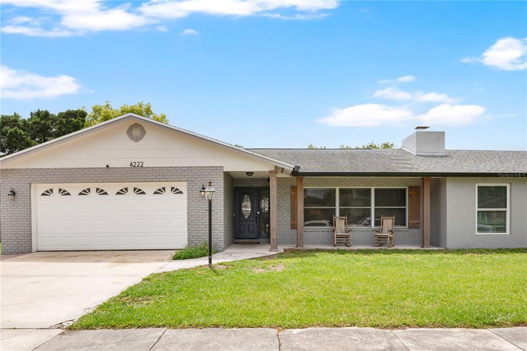 4222 Old Dominion Road Orlando, FL 32812 - Photo 42 of 49 a front view of a house with a garden and plants