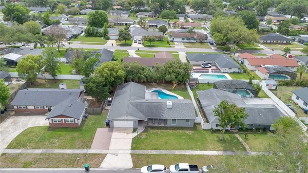 an aerial view of residential houses with outdoor space and swimming pool