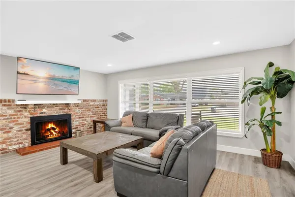 a living room with furniture and a fireplace