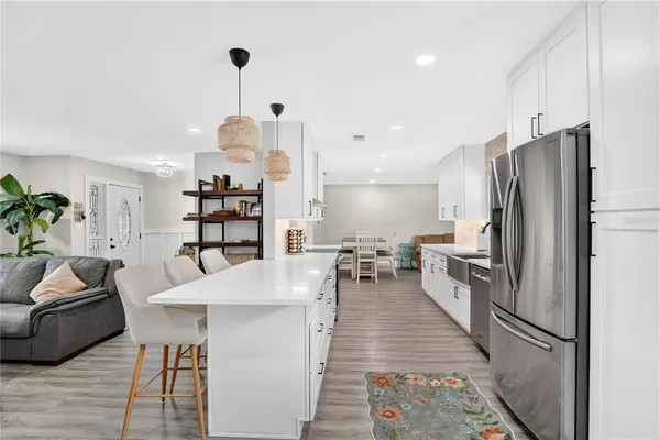 a kitchen with stainless steel appliances a refrigerator and a stove