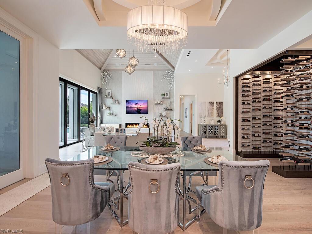 714 Killdeer Place Naples, FL 34108 - Photo 12 of 34 a very nice looking dining room with a large dining table and a large window