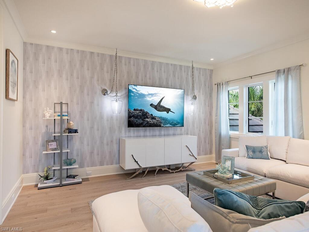 714 Killdeer Place Naples, FL 34108 - Photo 15 of 34 a living room with furniture and a flat screen tv
