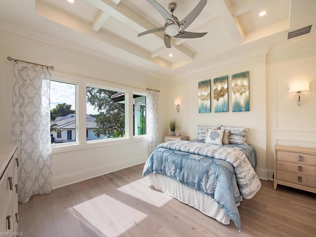 714 Killdeer Place Naples, FL 34108 - Photo 18 of 34 a bedroom with a large bed and a window