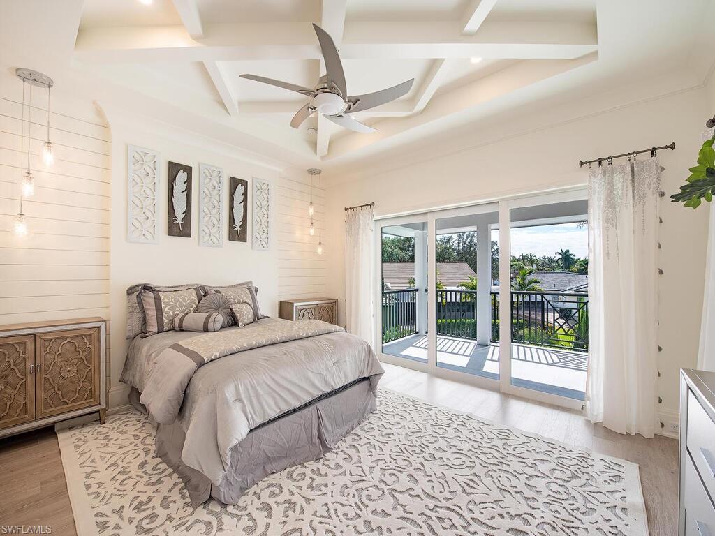 714 Killdeer Place Naples, FL 34108 - Photo 19 of 34 a bedroom with a large bed and a window