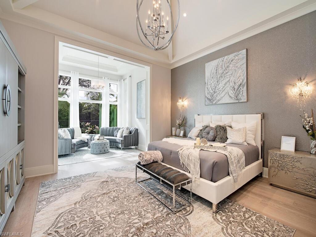 714 Killdeer Place Naples, FL 34108 - Photo 20 of 34 a bed room with a bed and a couch