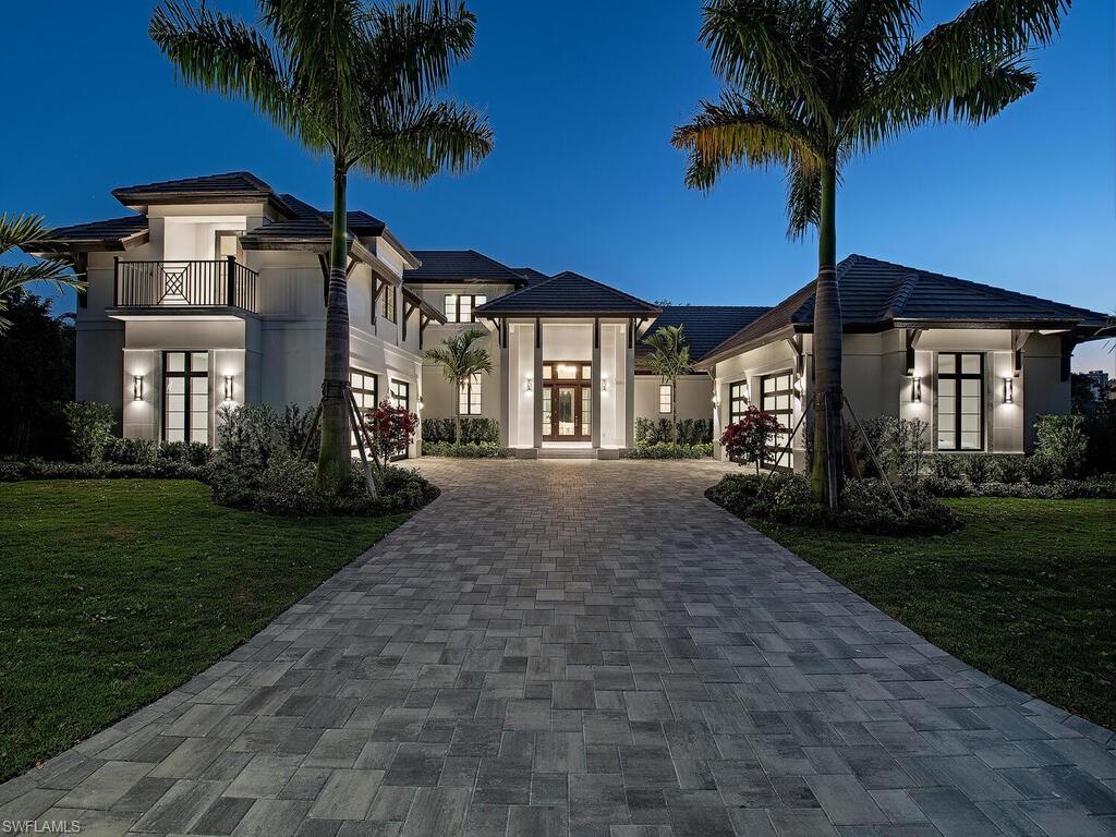 714 Killdeer Place Naples, FL 34108 - Photo 23 of 34 a front view of a house with garden