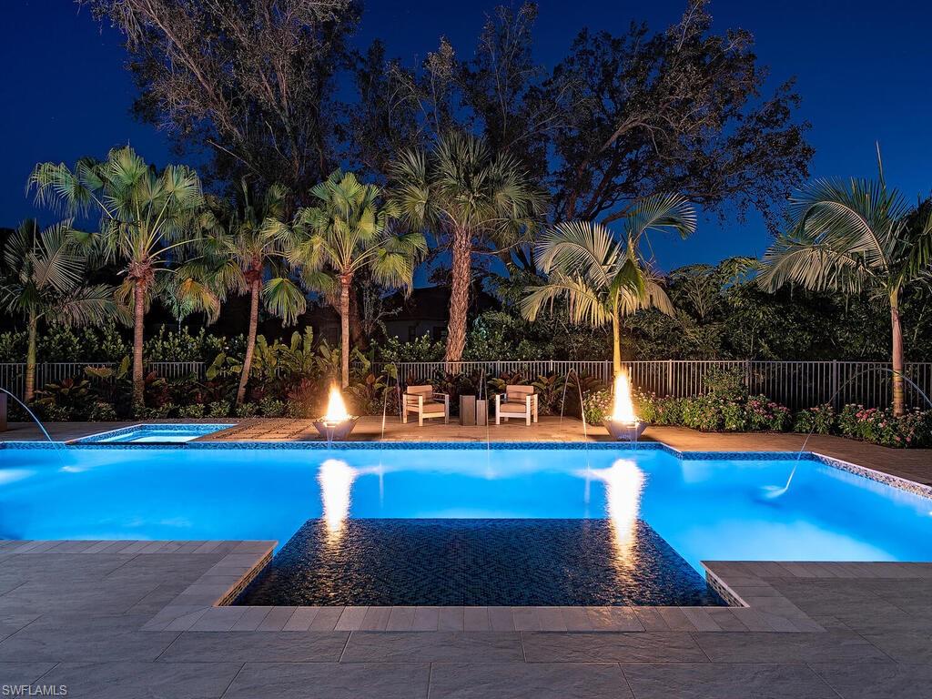 714 Killdeer Place Naples, FL 34108 - Photo 26 of 34 a view of a swimming pool with an outdoor space and seating area