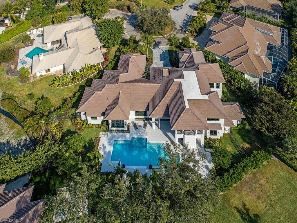 714 Killdeer Place Naples, FL 34108 - Photo 3 of 34 an aerial view of a house with garden space and street view