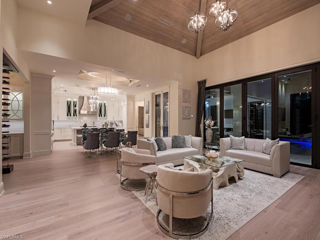 714 Killdeer Place Naples, FL 34108 - Photo 32 of 34 a living room with furniture and a large window