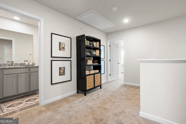 a view of kitchen with refrigerator and white cabinets