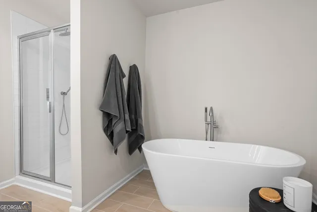 a bathroom with a tub and shower