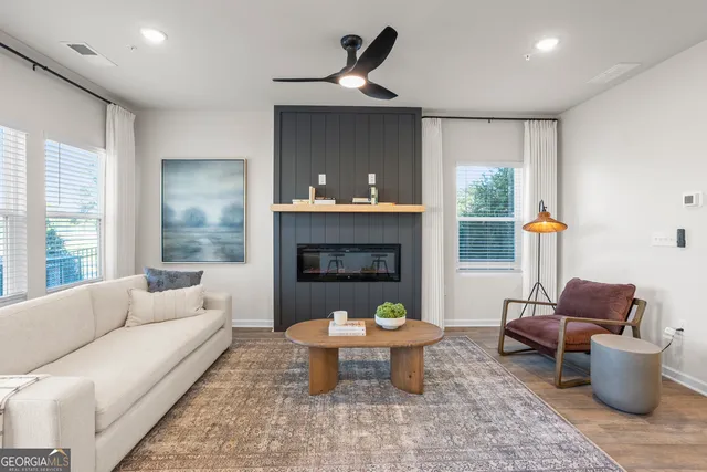 a living room with furniture and a fireplace