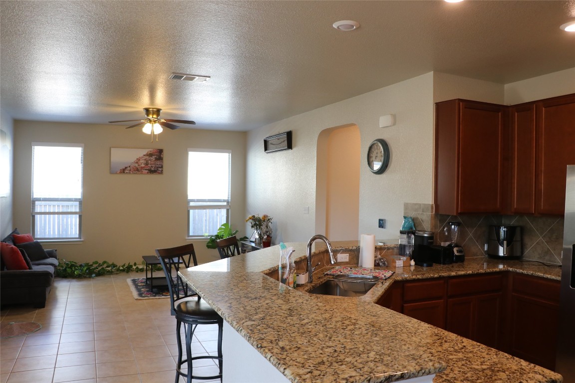 321 Parrot Tulip View Pflugerville, TX 78660 - Photo 33 of 33 a kitchen with a table chairs sink and cabinets