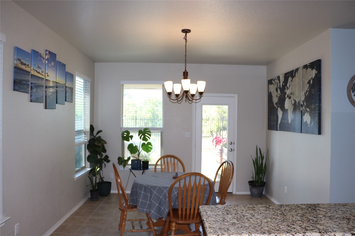 321 Parrot Tulip View Pflugerville, TX 78660 - Photo 15 of 33 a dining room with furniture a chandelier and window
