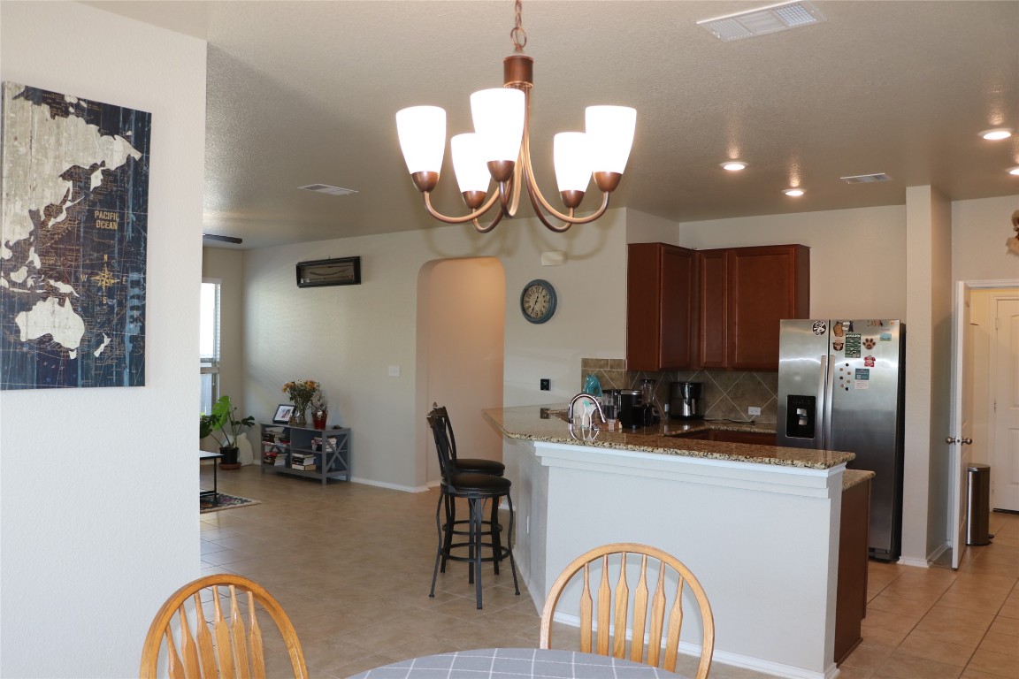 321 Parrot Tulip View Pflugerville, TX 78660 - Photo 16 of 33 a kitchen with a sink appliances and a dining table
