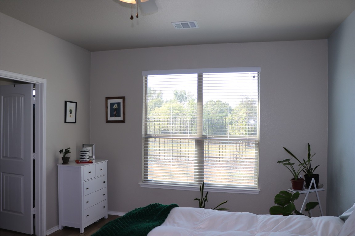 321 Parrot Tulip View Pflugerville, TX 78660 - Photo 22 of 33 a bedroom with windows and balcony