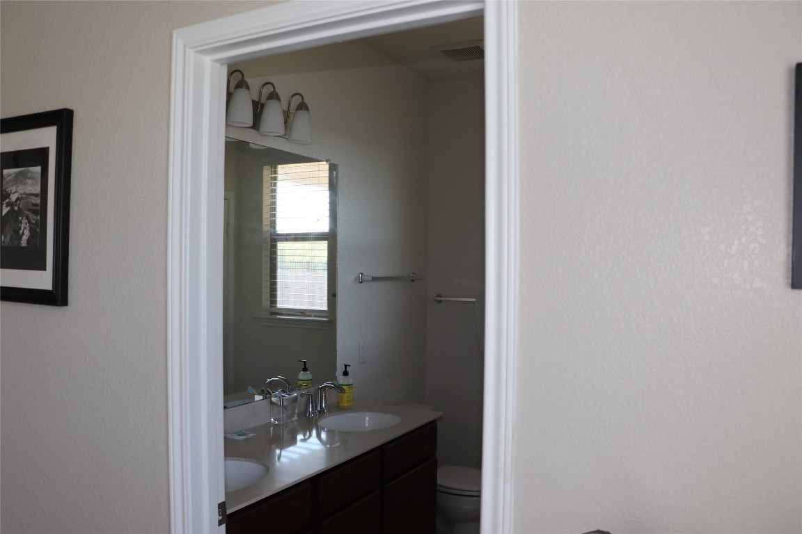 321 Parrot Tulip View Pflugerville, TX 78660 - Photo 26 of 33 a bathroom with a sink and a mirror