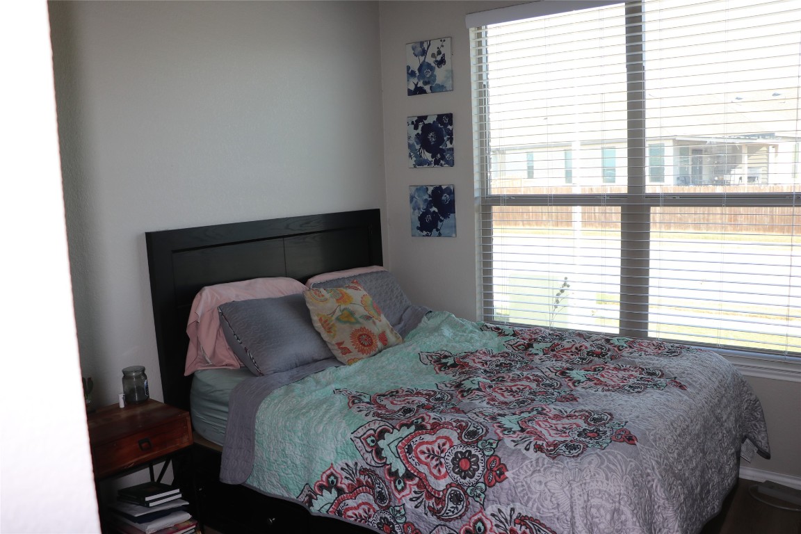321 Parrot Tulip View Pflugerville, TX 78660 - Photo 4 of 33 a bed sitting in a bedroom next to a window