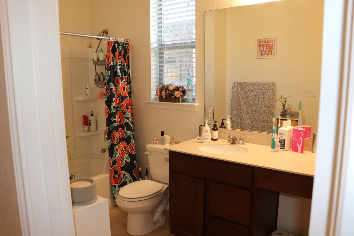 321 Parrot Tulip View Pflugerville, TX 78660 - Photo 6 of 33 a bathroom with a sink vanity mirror and toilet