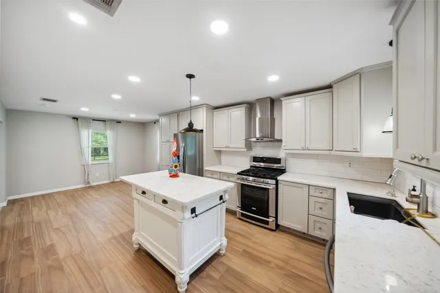 a kitchen with a stove a sink and a refrigerator