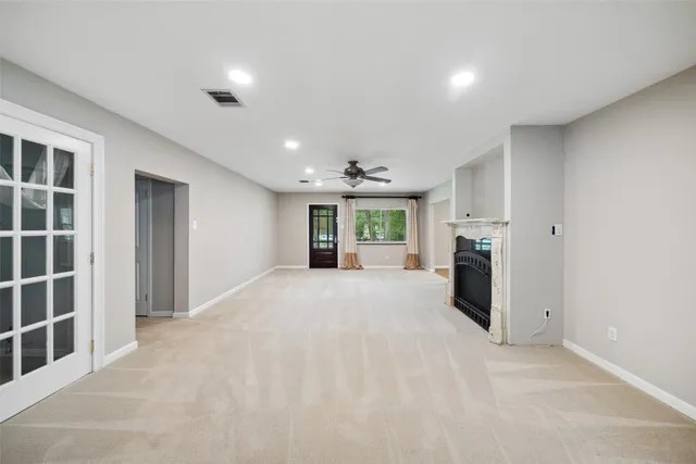 a view of a kitchen with refrigerator and window