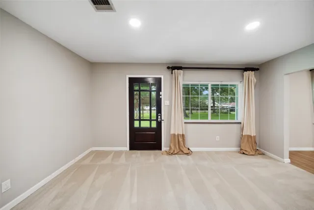 a view of an empty room with a window