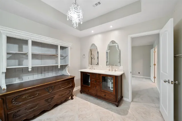 a spacious bathroom with a double vanity sink and a mirror