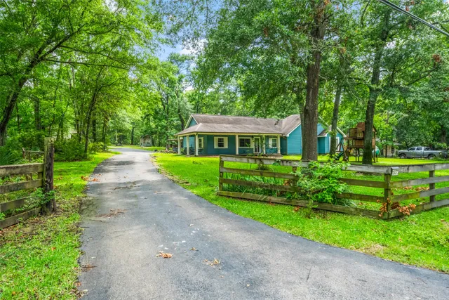 a front view of a house with a yard table and chairs