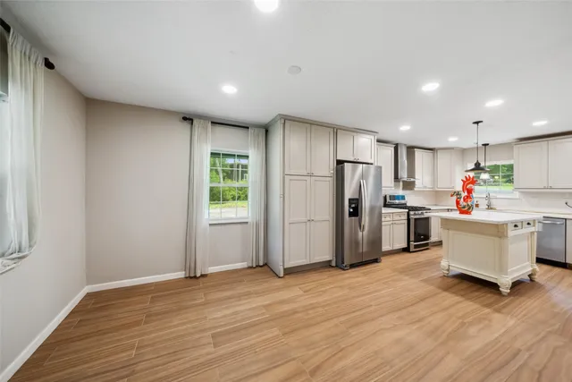 a kitchen with refrigerator and cabinets