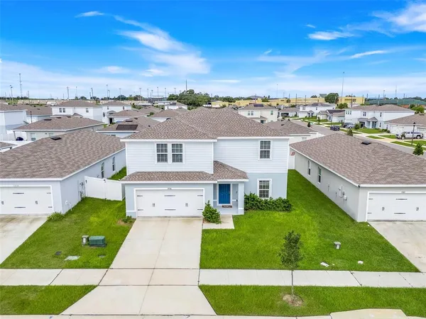 a aerial view of multiple houses with a yard