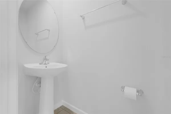 an aerial view of residential houses with outdoor space and ocean view